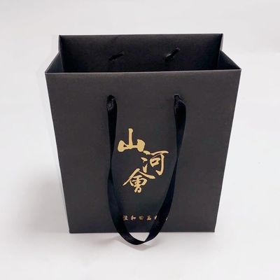 Buen precio Compras de las bolsas de papel de Kraft del café/del regalo con el logotipo del sello de la hoja de oro en línea